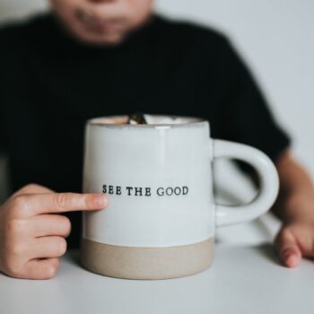 self-care, child pointing to cup that says see the good